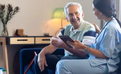 Elderly man talking with a healthcare worker at home