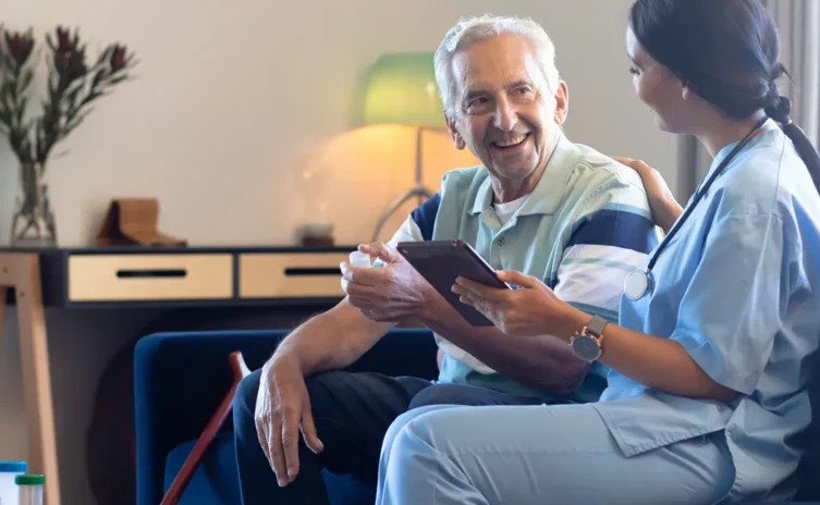 Elderly man talking with a healthcare worker at home
