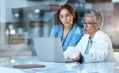 Two female doctors looking at a laptop