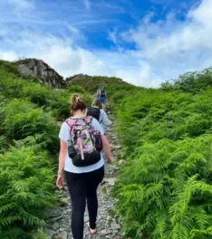 Woman hiking through a hillside